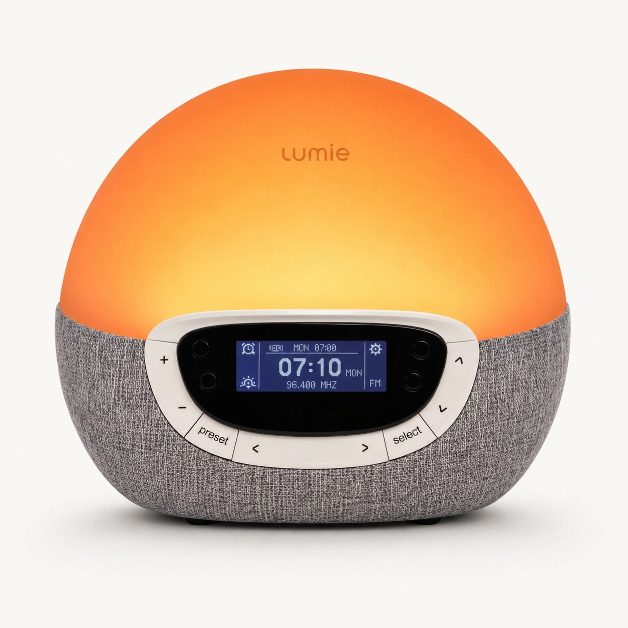 Lumie Bodyclock Rise300 alarm clock with sunrise simulation glowing warmly on a bedside surface